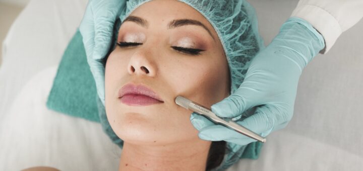 woman doing liposuction on her face