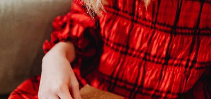 Woman Opening a Christmas Present