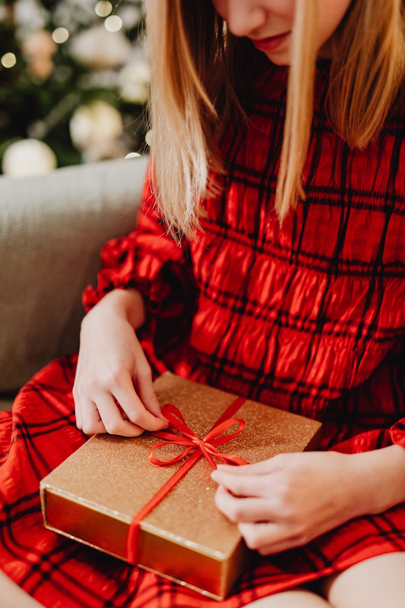 Woman Opening a Christmas Present